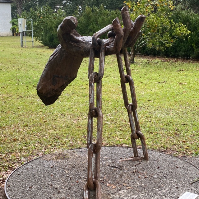 Sculpture of a hand holding a chain symbolizing emancipation from chattel slavery at the Whitney Plantation in Louisiana